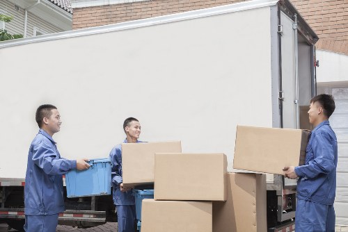 Van and van staff coordinating safe handling of furniture